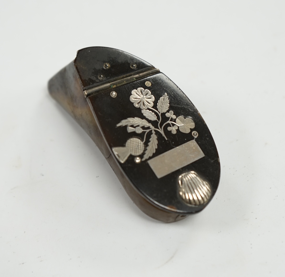 A 19th century Scottish white metal inlaid shaped horn snuff box, 87mm. Condition - poor